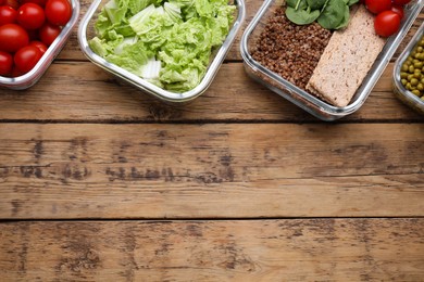 Glass containers with different fresh products on wooden table, flat lay. Space for text