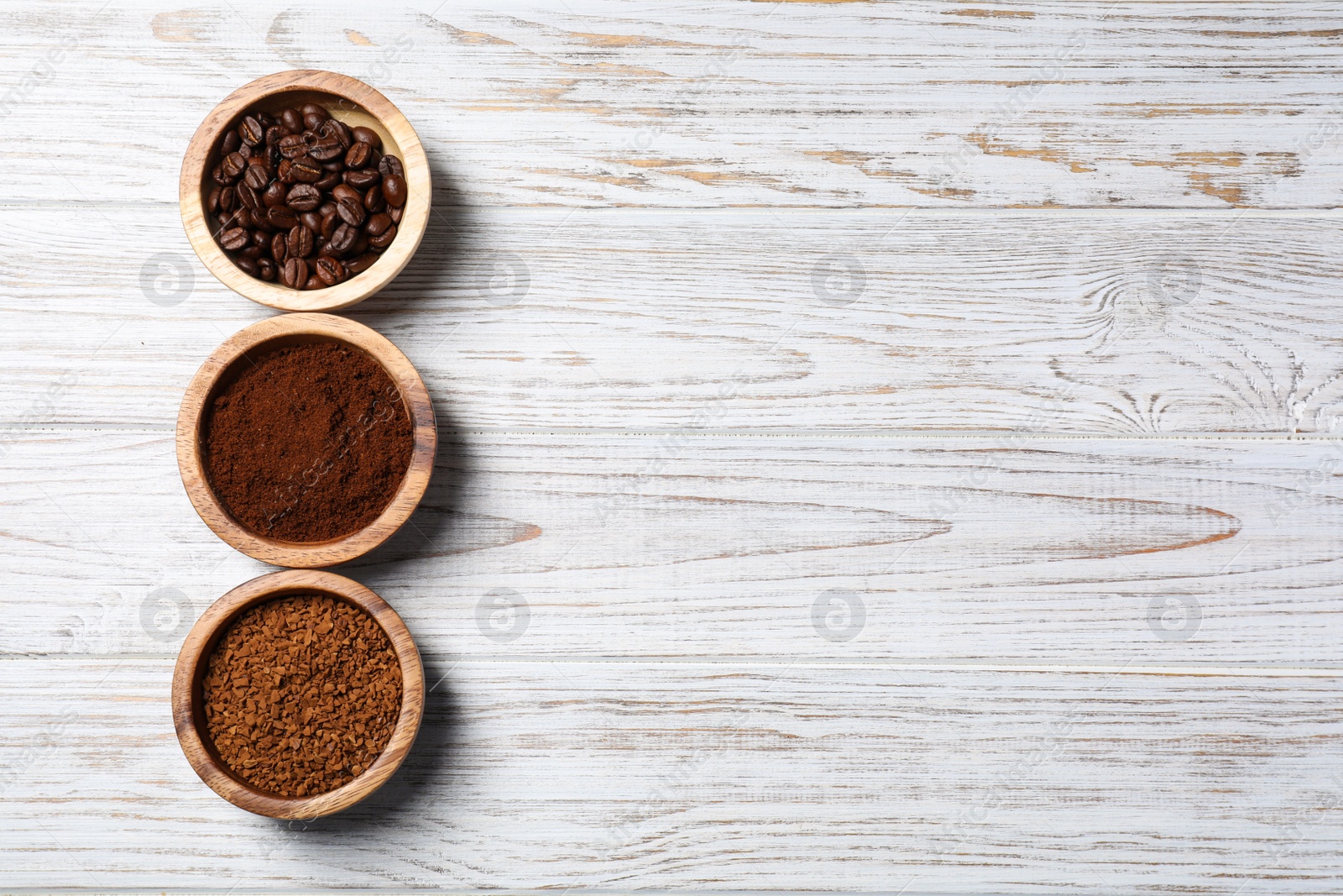 Photo of Instant, ground coffee and roasted beans on white wooden table, flat lay. Space for text