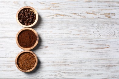 Instant, ground coffee and roasted beans on white wooden table, flat lay. Space for text