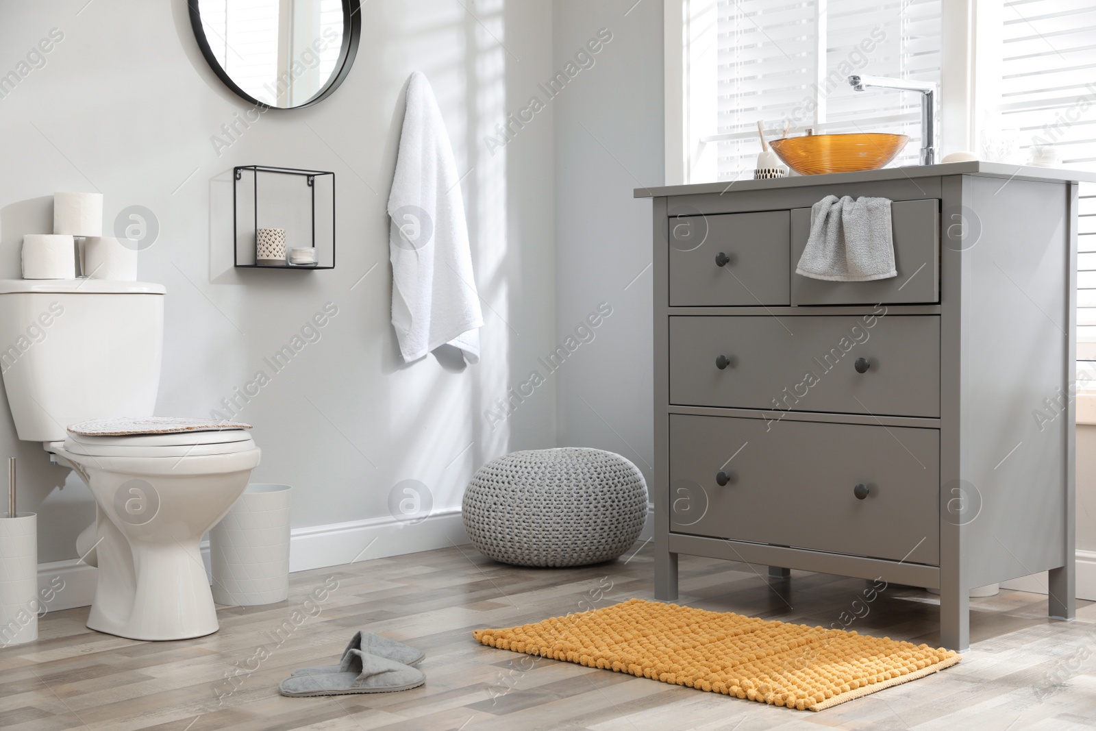 Photo of Mat near base cabinet with sink in bathroom