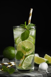 Delicious mojito and ingredients on marble board