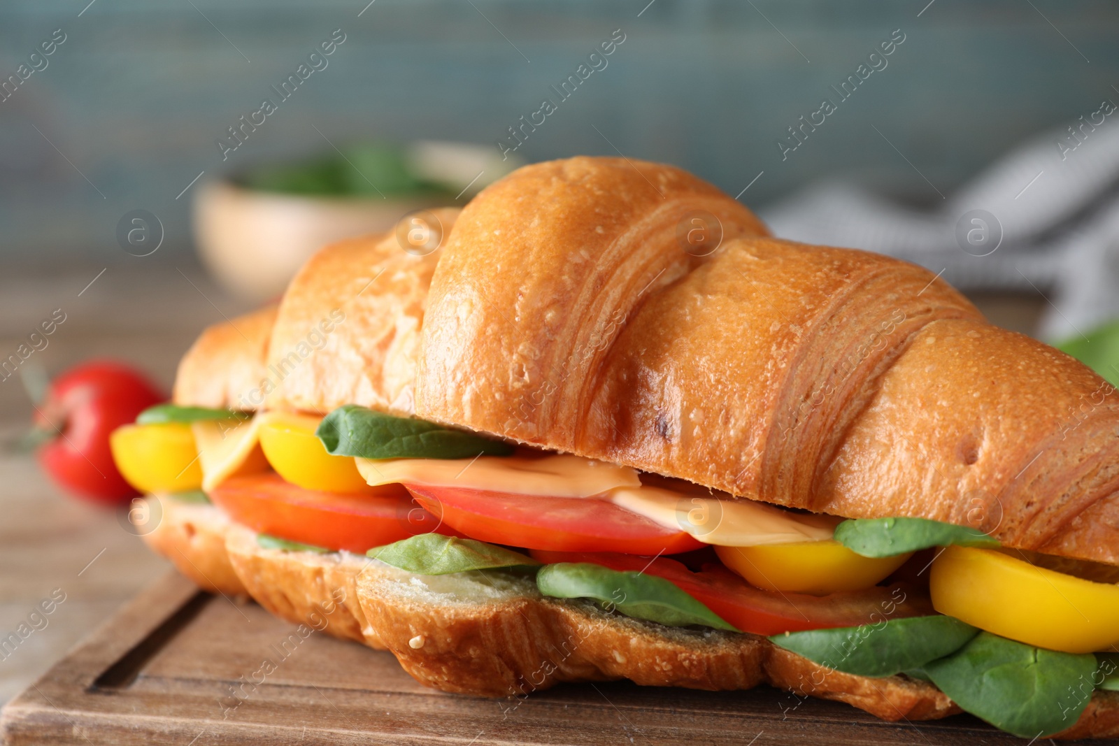 Photo of Tasty vegetarian croissant sandwich on table, closeup