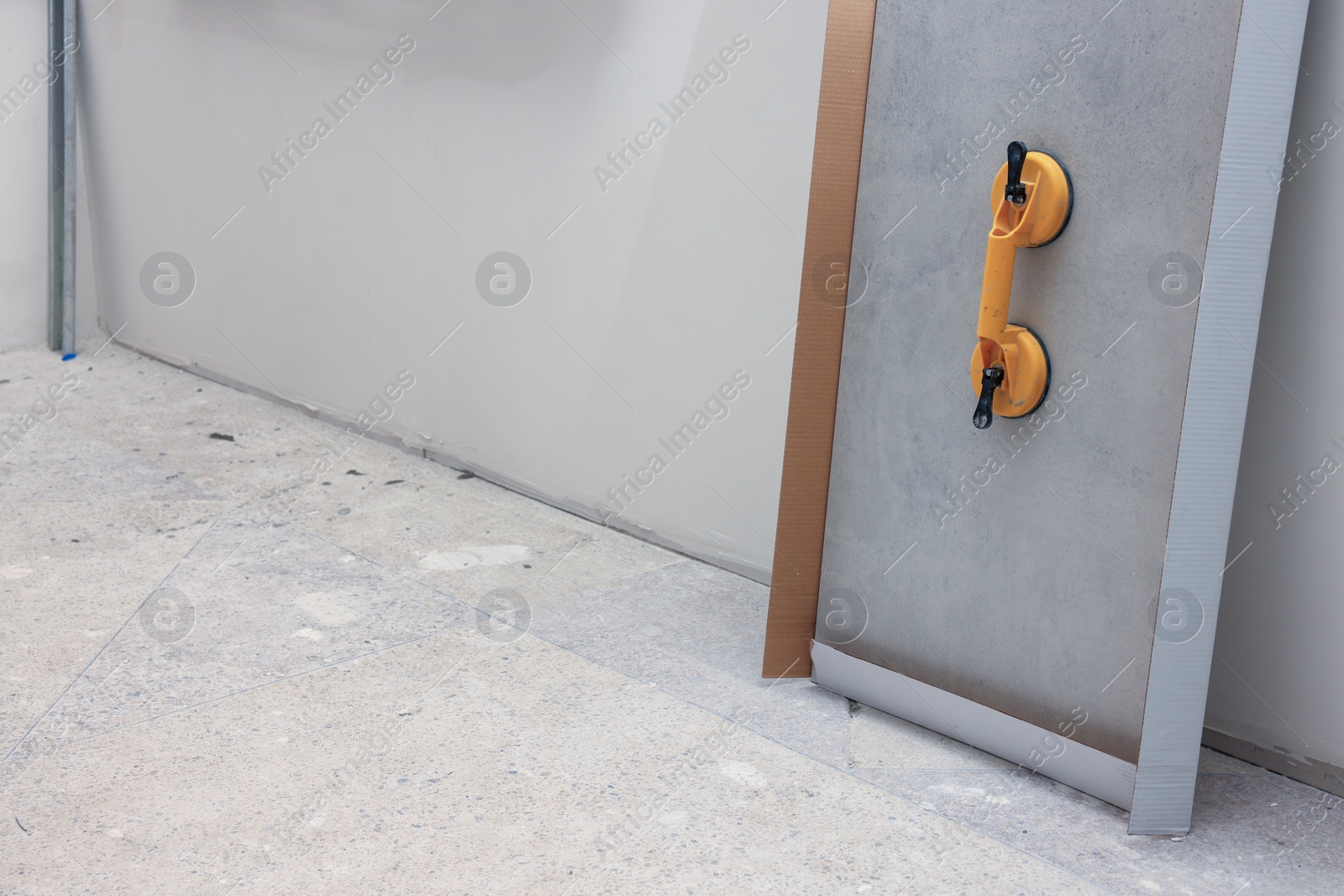 Photo of Yellow suction plate attached to tile near wall