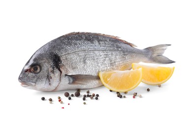 Photo of Raw dorado fish, lemon wedges and peppercorns isolated on white