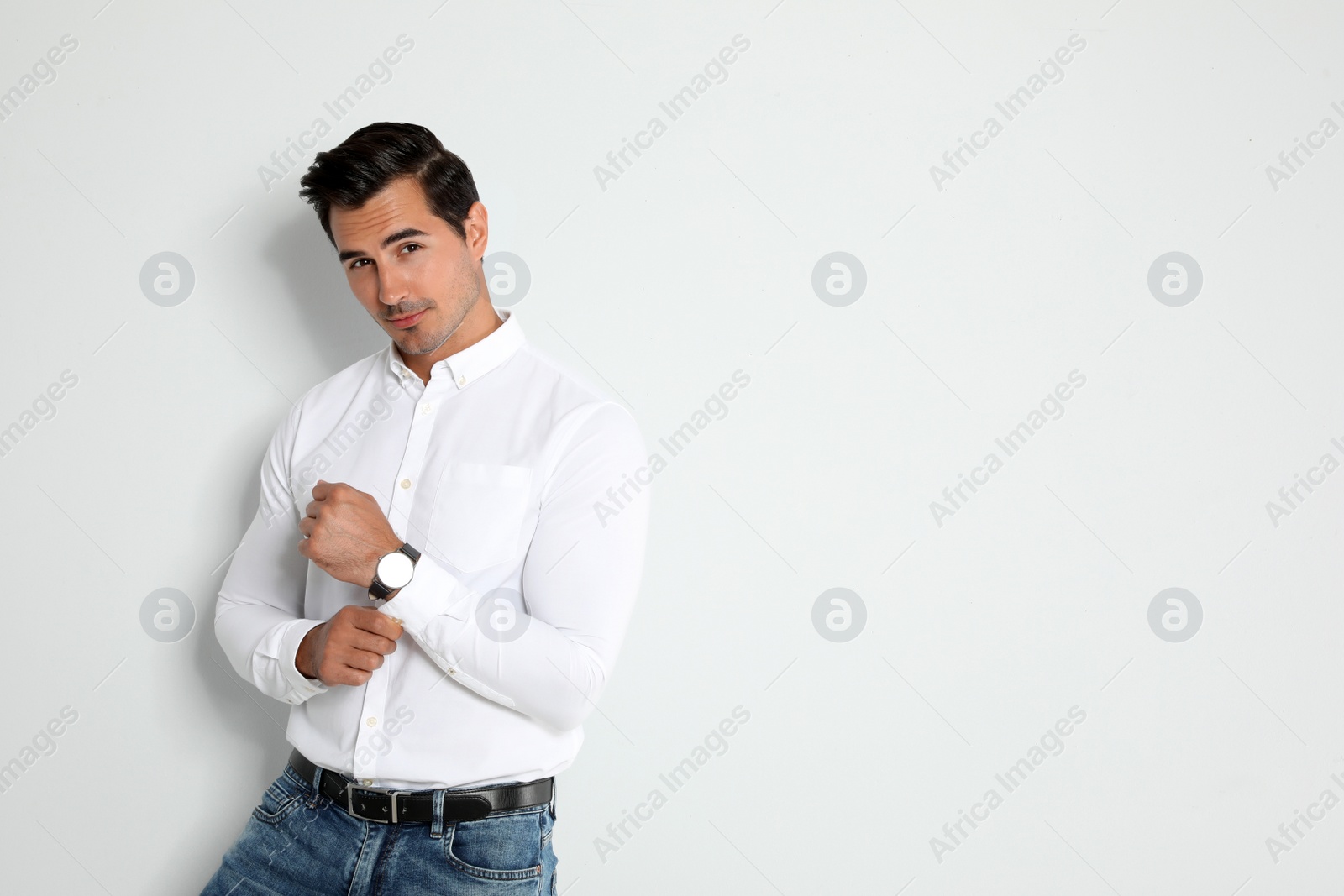 Photo of Portrait of handsome young man on light background. Space for text