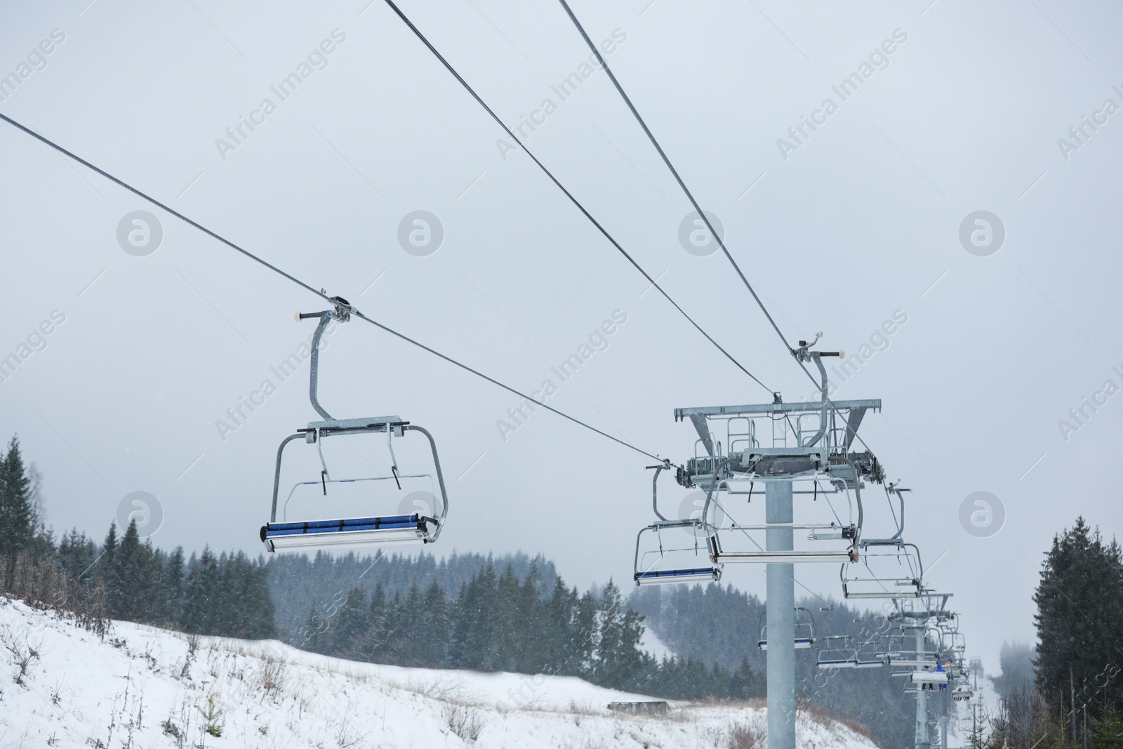 Photo of Empty chairlift at ski resort. Winter vacation