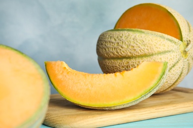 Photo of Tasty fresh melon on wooden board, closeup