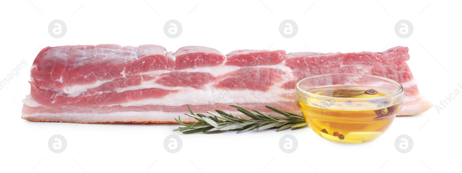 Photo of Piece of raw pork belly, rosemary and oil with spices isolated on white