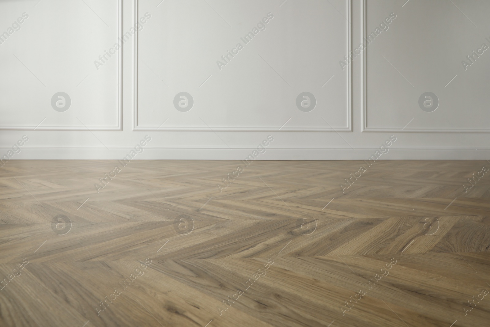 Photo of Parquet floor in light spacious empty room