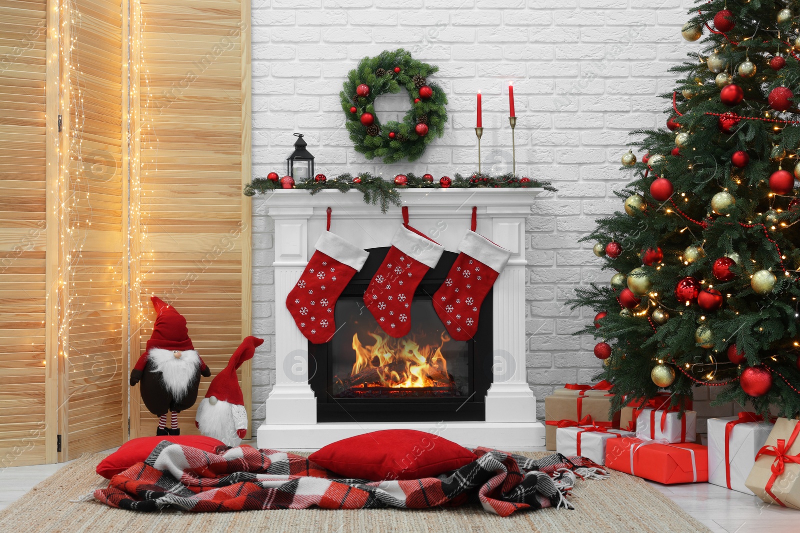 Photo of Cosy room with tree and fireplace decorated for Christmas. Interior design