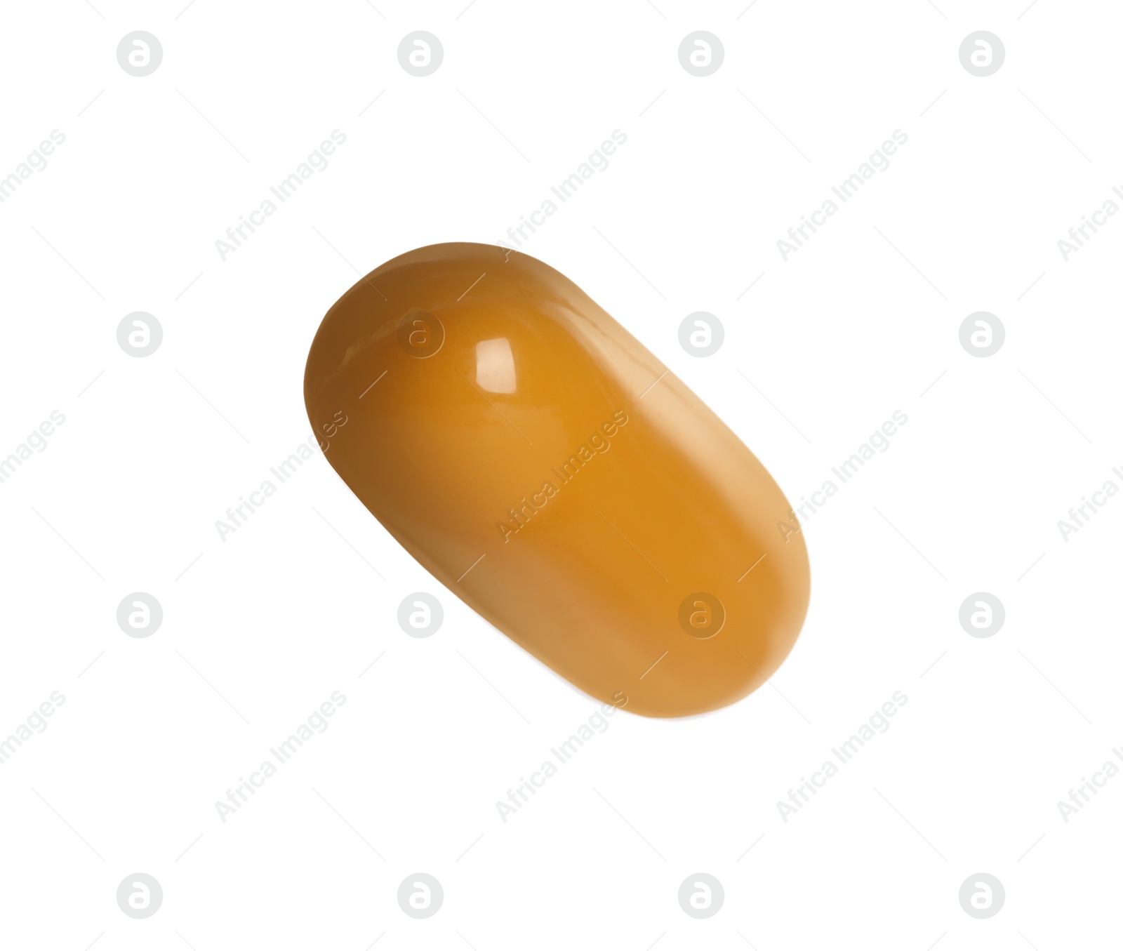 Photo of One light brown pill on white background. Medicinal treatment