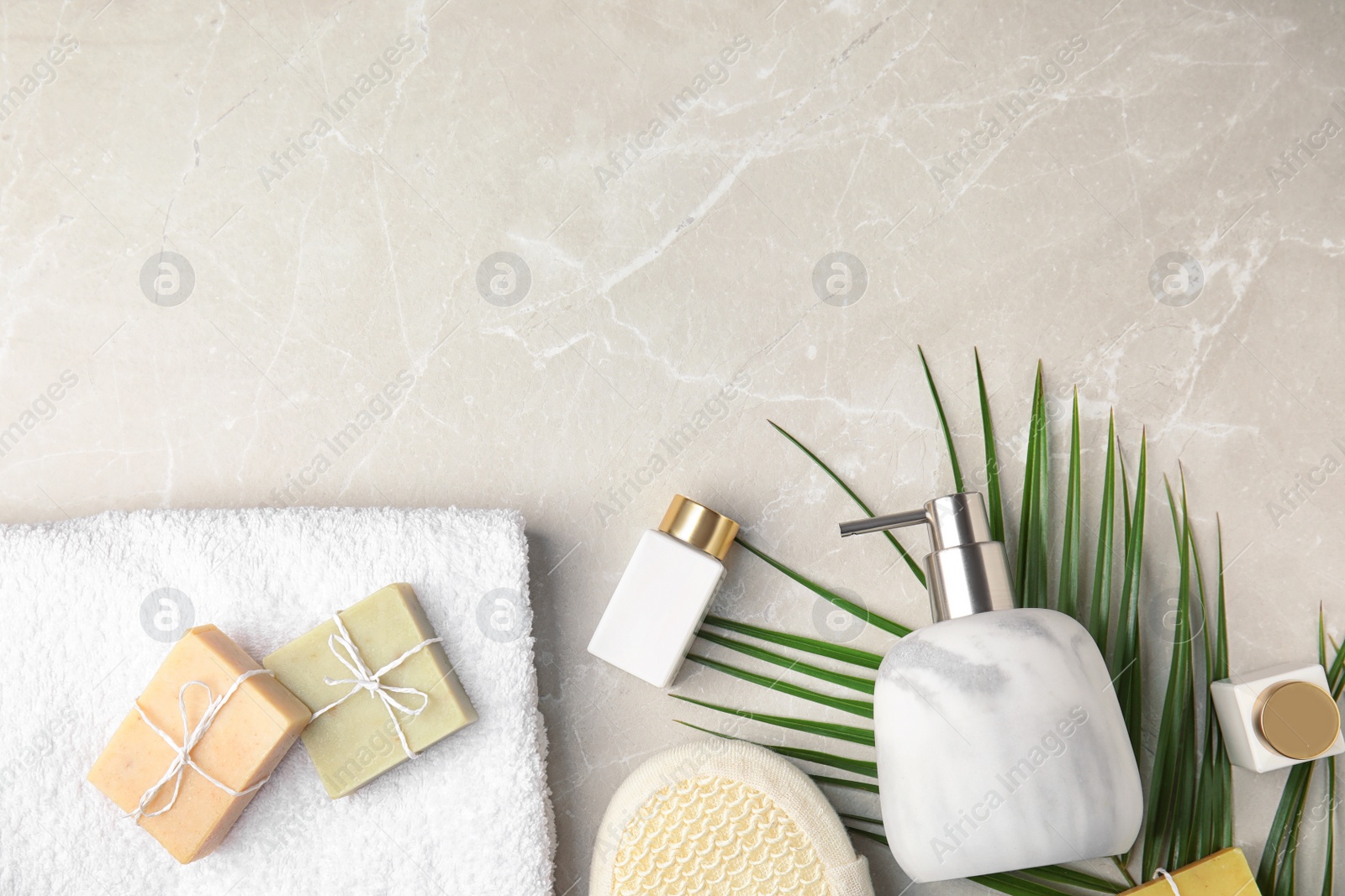 Photo of Flat lay composition with soap dispenser on marble background. Space for text