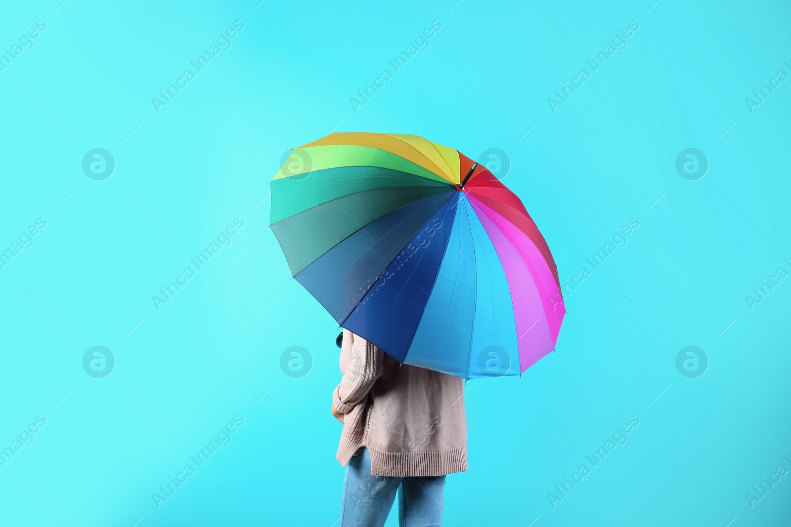 Photo of Woman with rainbow umbrella on color background