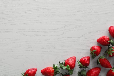 Photo of Food photography. Delicious ripe strawberries on white wooden table, flat lay with space for text