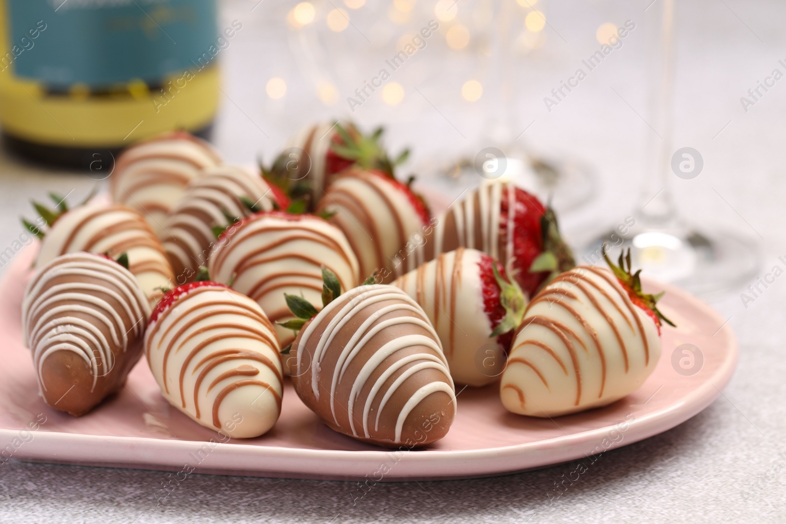 Photo of Delicious chocolate covered strawberries on light table, closeup