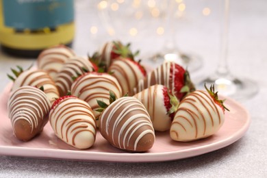 Photo of Delicious chocolate covered strawberries on light table, closeup