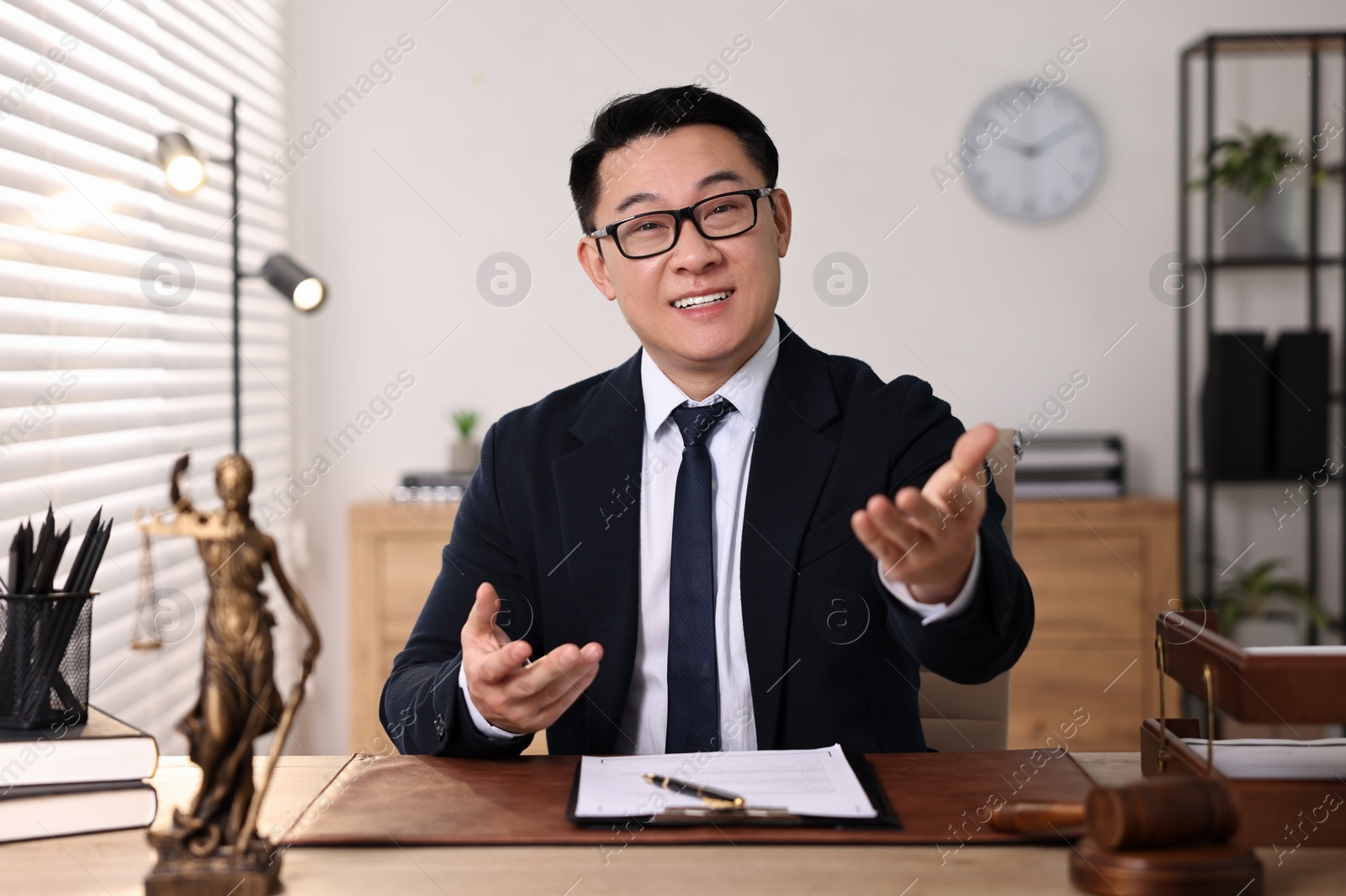 Photo of Happy notary working at wooden table in office