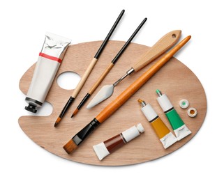Photo of Wooden palette with oil paints and tools on white background, top view