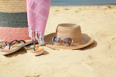 Photo of Setdifferent stylish beach accessories on sand