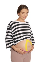 Pregnant woman with kinesio tapes on her belly against white background