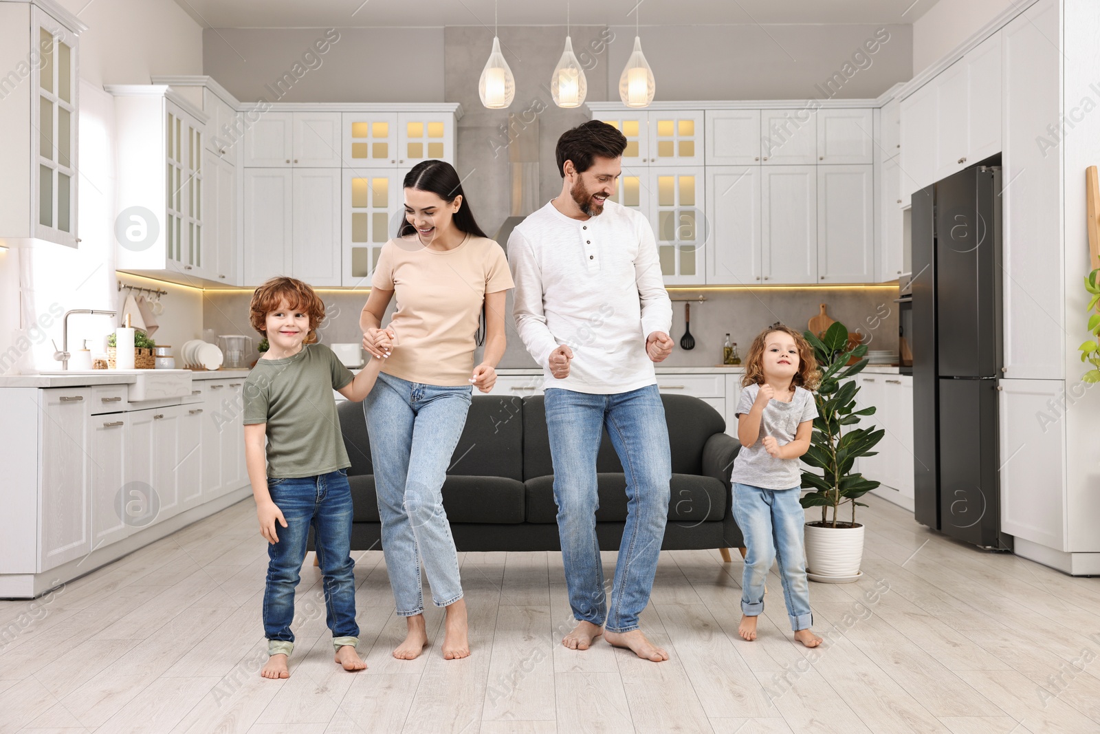 Photo of Happy family dancing and having fun at home