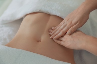 Woman receiving professional belly massage, closeup view