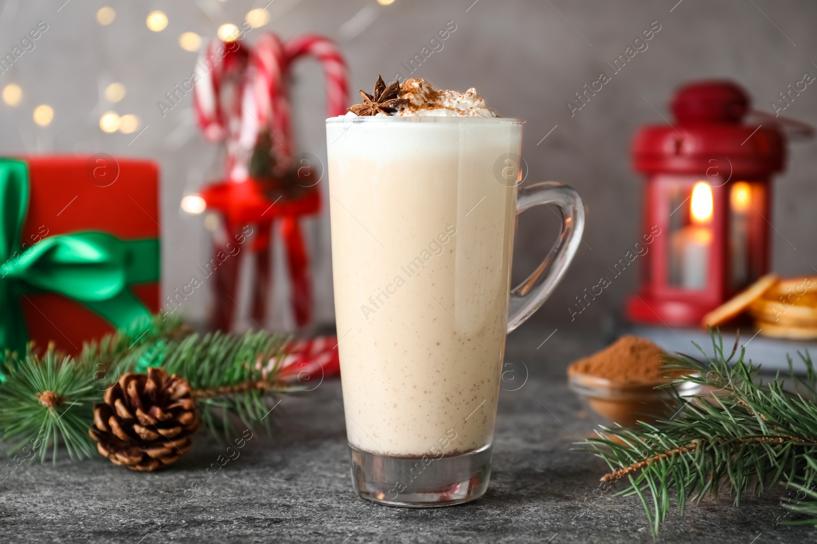 Photo of Delicious Christmas cocktail with liqueur on grey table