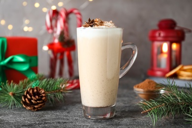 Photo of Delicious Christmas cocktail with liqueur on grey table