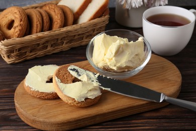 Photo of Tasty homemade butter, cookies and tea on wooden table