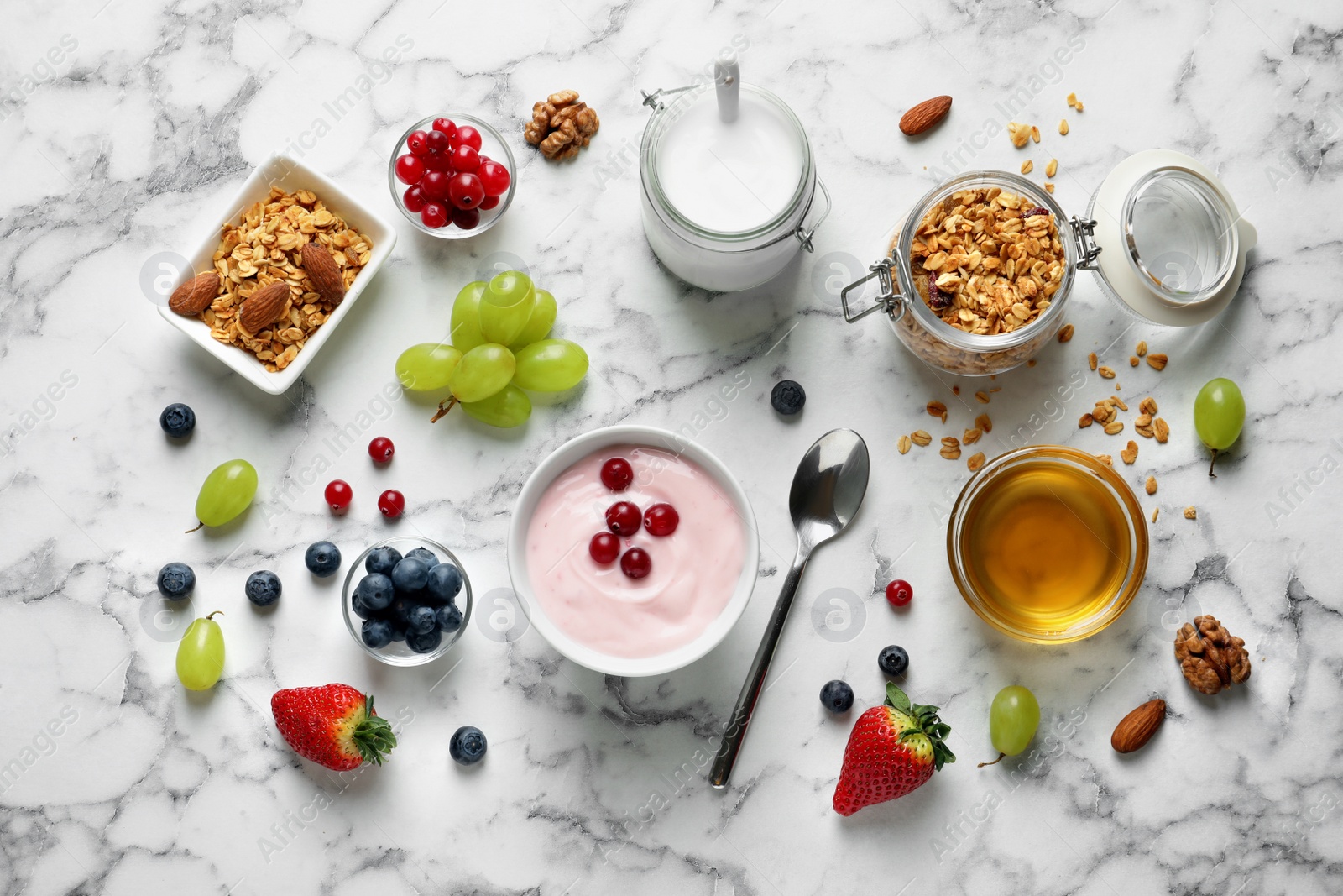 Photo of Flat lay composition with tasty yogurt for breakfast on marble background