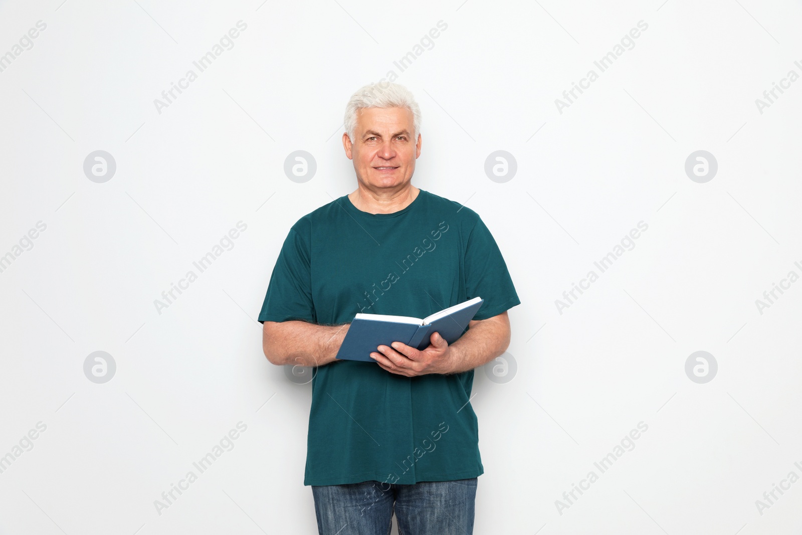 Photo of Senior man reading book on white background, space for text