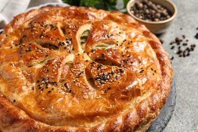 Photo of Tasty homemade pie on grey table, closeup