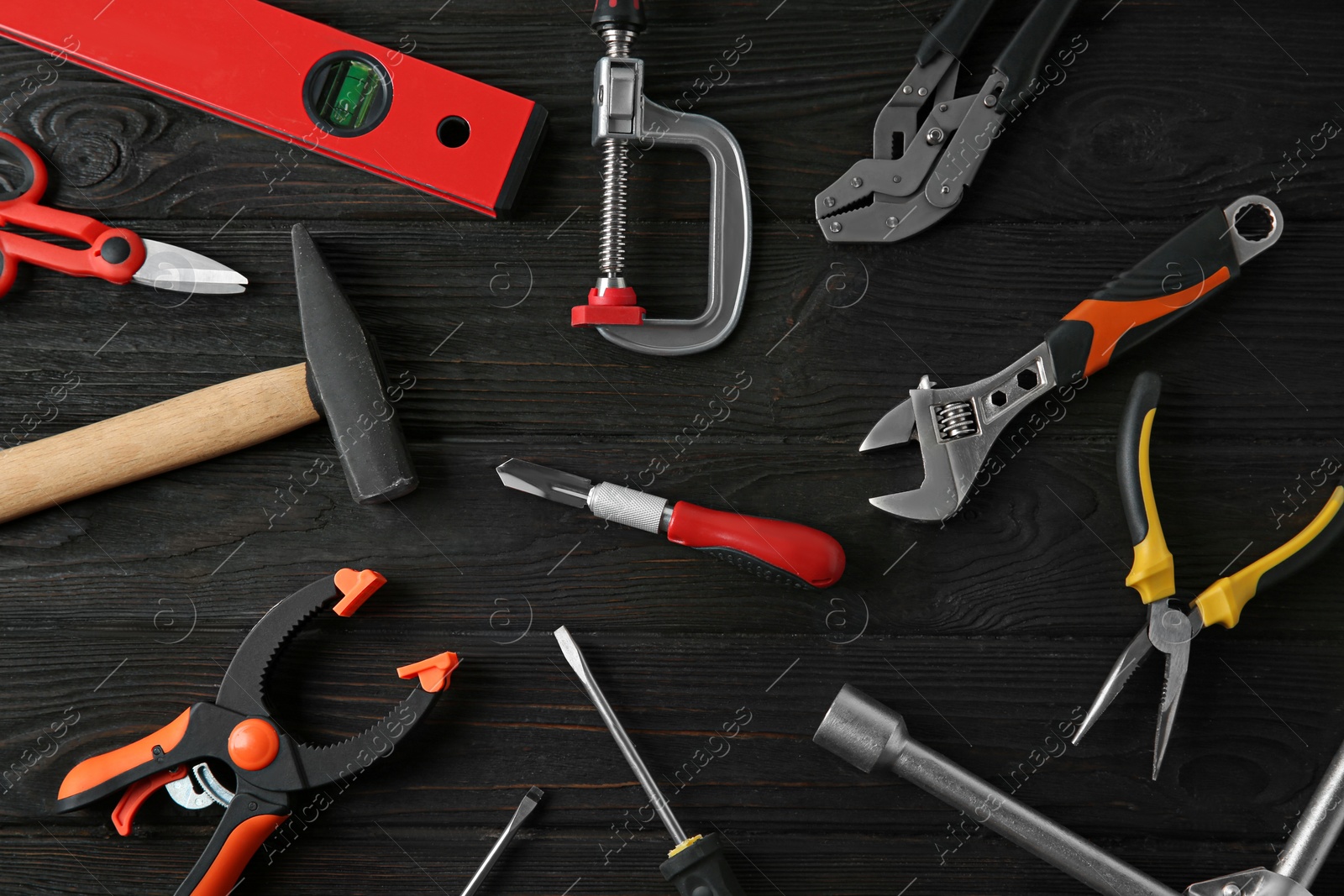 Photo of Set of repair tools on dark wooden background, flat lay