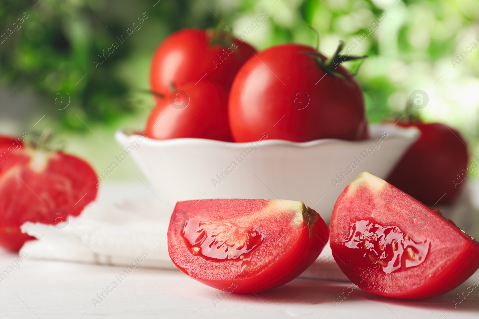 Photo of Fresh ripe tomatoes on white wooden table, closeup