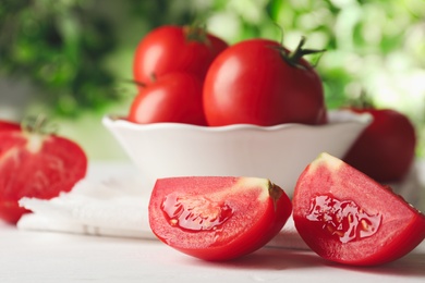 Photo of Fresh ripe tomatoes on white wooden table, closeup