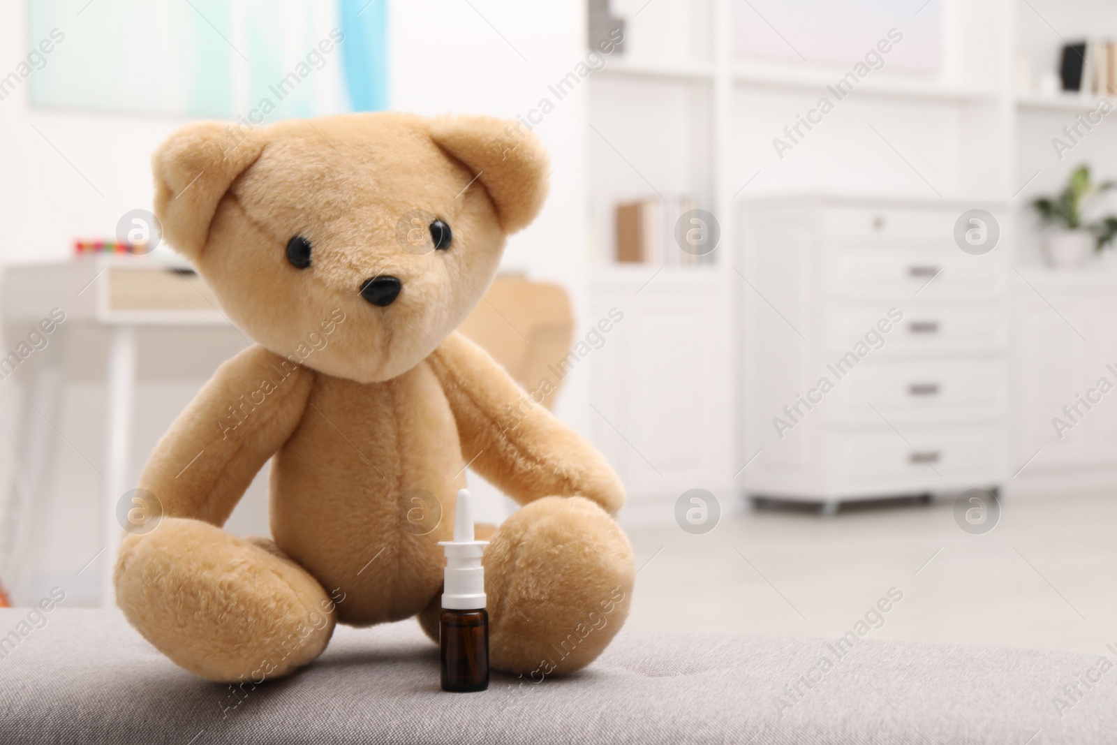 Photo of Toy cute bear with nasal spray indoors, space for text