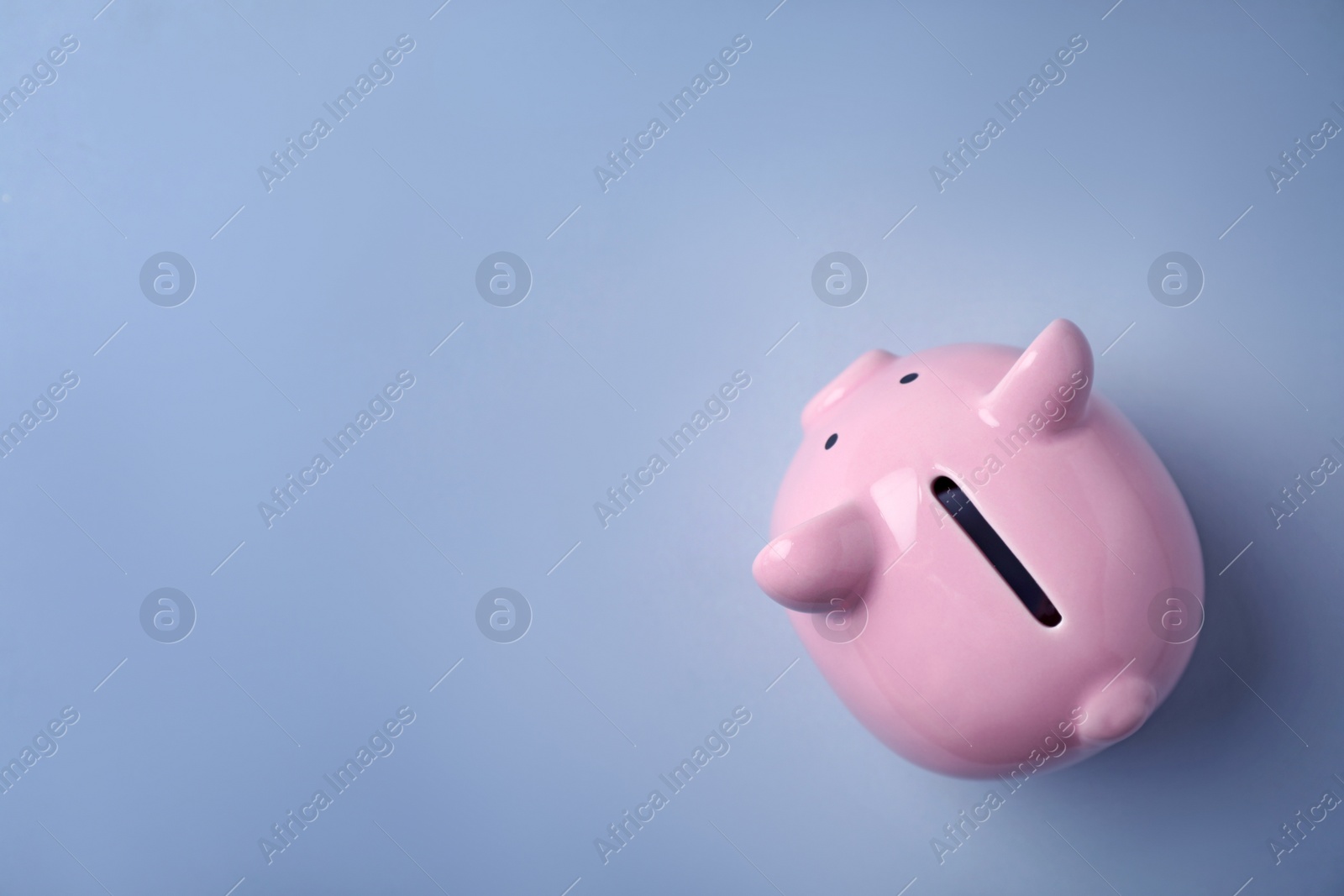 Photo of Pink piggy bank on color background, top view