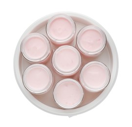 Photo of Modern yogurt maker with full jars on white background, top view