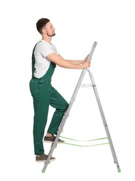 Worker in uniform climbing up metal ladder on white background
