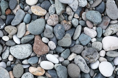 Many different pebbles as background, top view