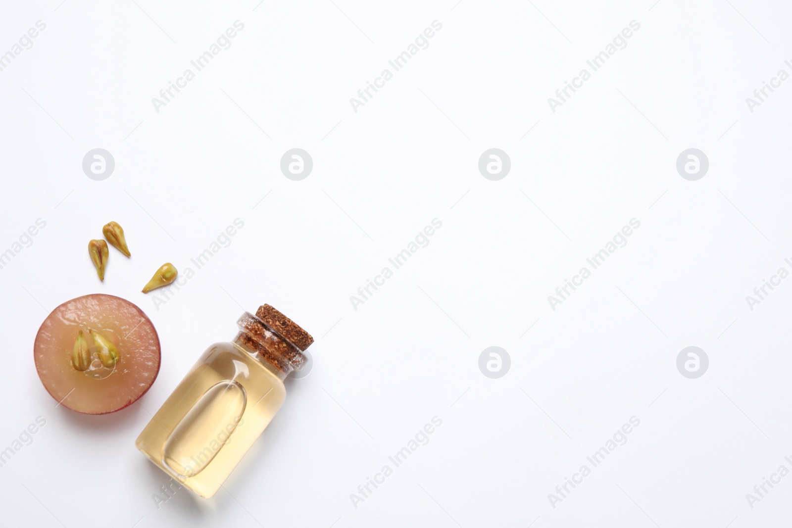 Photo of Composition with natural grape seed oil on white background, top view. Organic cosmetic