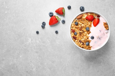 Photo of Tasty homemade granola  served on grey table, flat lay with space for text. Healthy breakfast