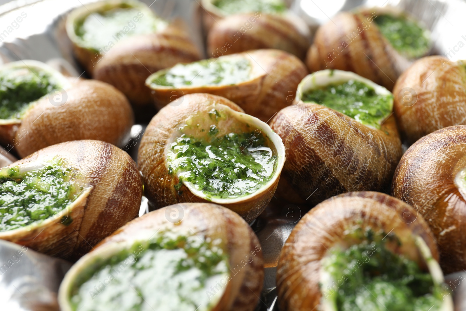 Photo of Delicious cooked snails on table, closeup view