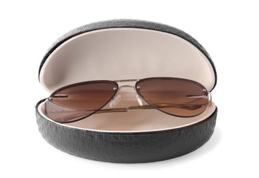 Photo of Stylish sunglasses in black leather case on white background