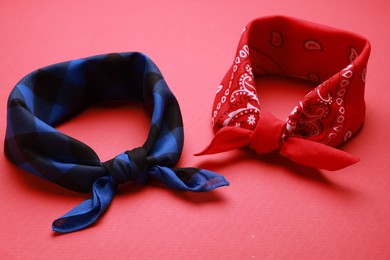 Photo of Tied bandanas with different patterns on red background