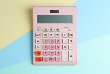 Modern calculator on color background, top view