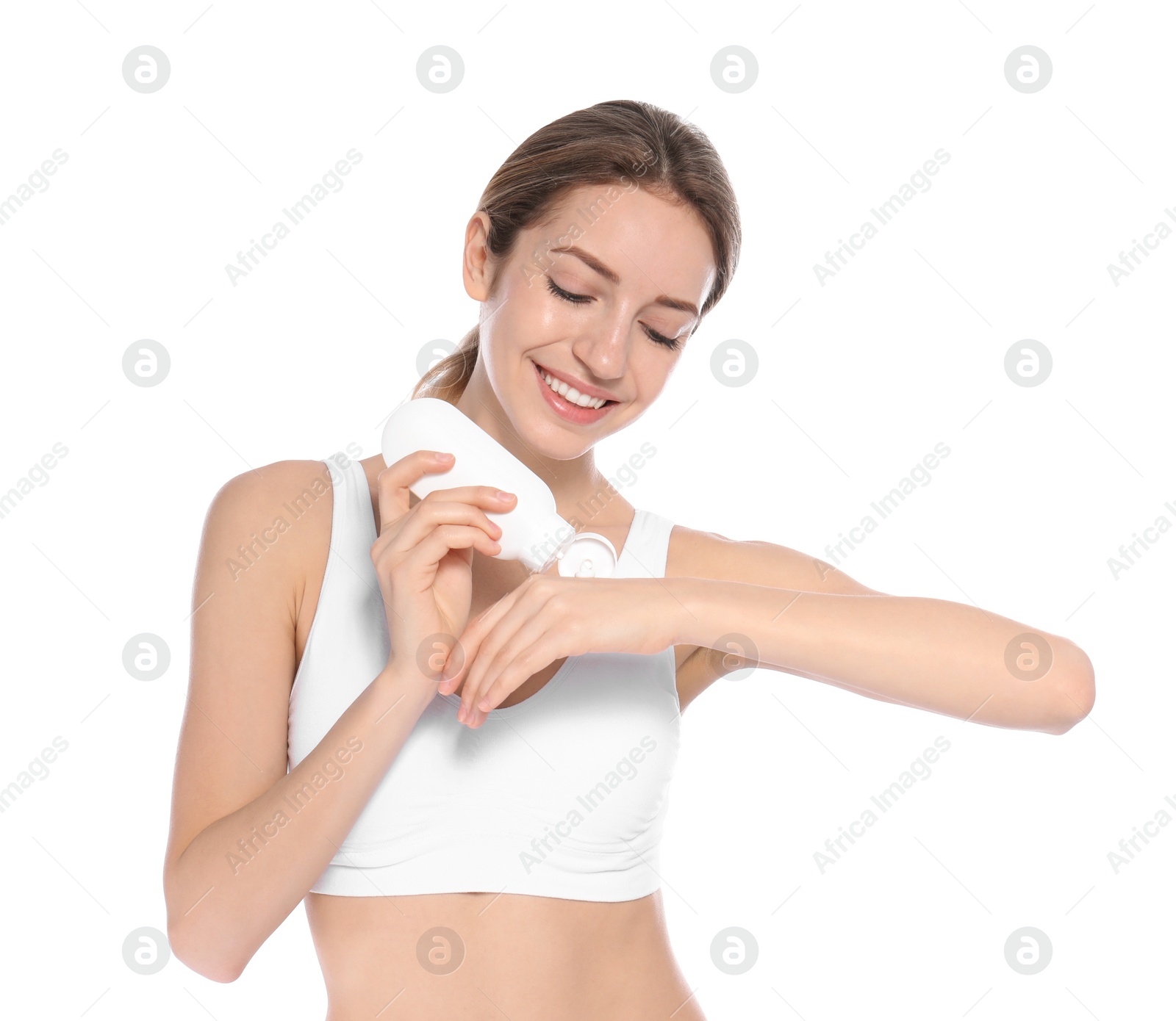 Photo of Young woman applying hand cream on white background. Beauty and body care