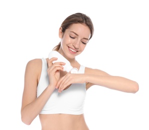 Young woman applying hand cream on white background. Beauty and body care