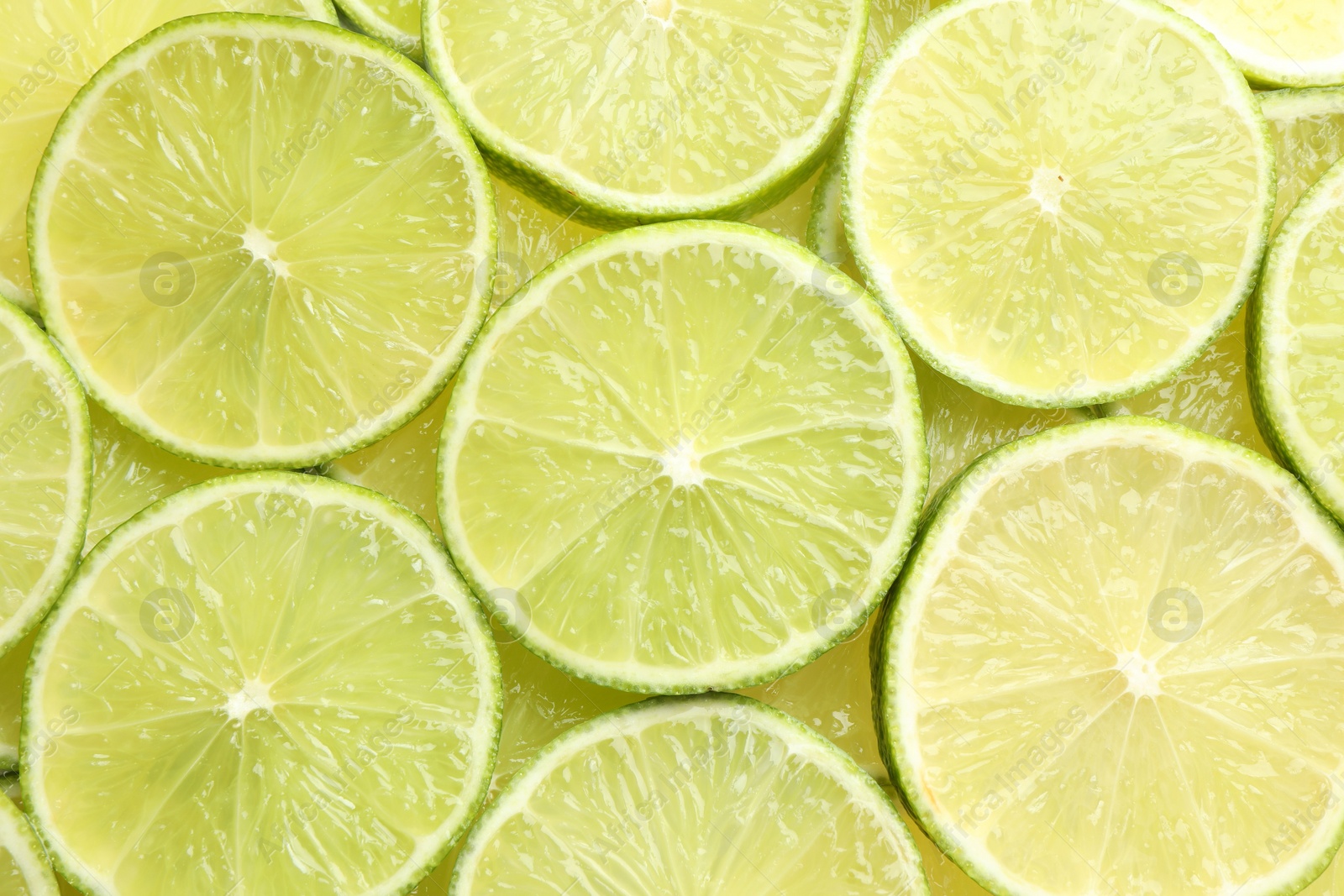 Photo of Fresh juicy lime slices as background, top view