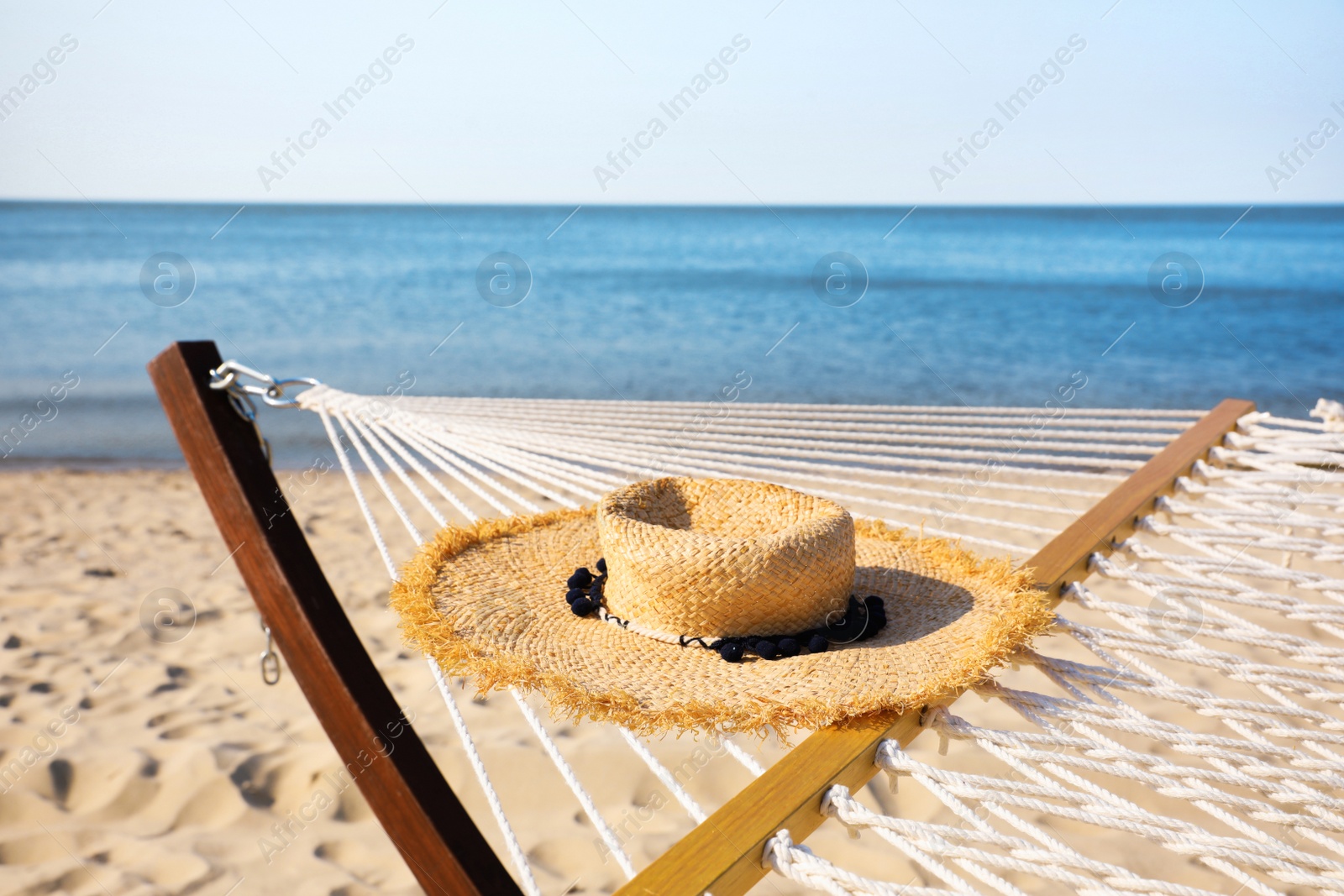 Photo of Hammock and hat at seaside. Time to relax